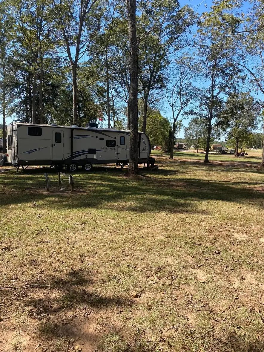 Travel trailer parked under shade trees at River Island RV Park